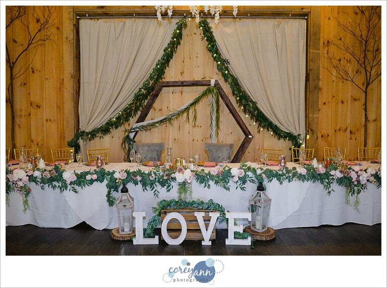 Pink and floral wedding reception decor at The Barn on Enchanted Acres