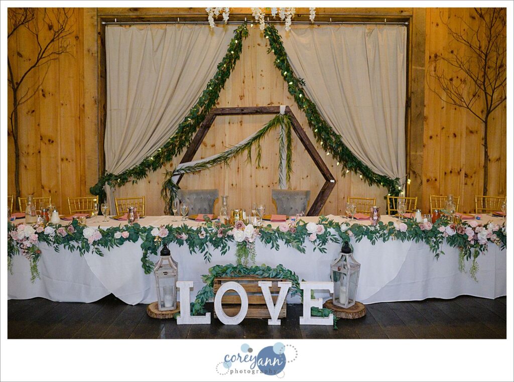 Pink and floral wedding reception decor at The Barn on Enchanted Acres