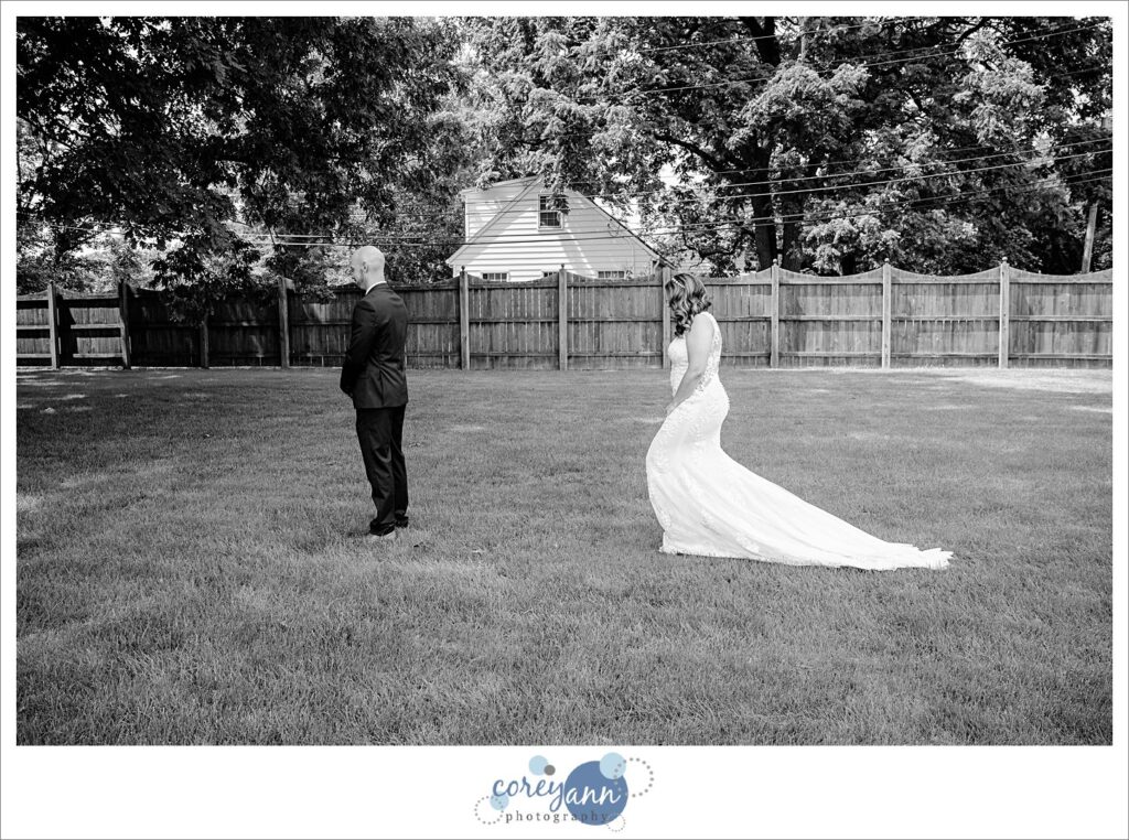 first look between bride and groom in the outdoor wedding ceremony space at Whitehall Columbia in Ohio