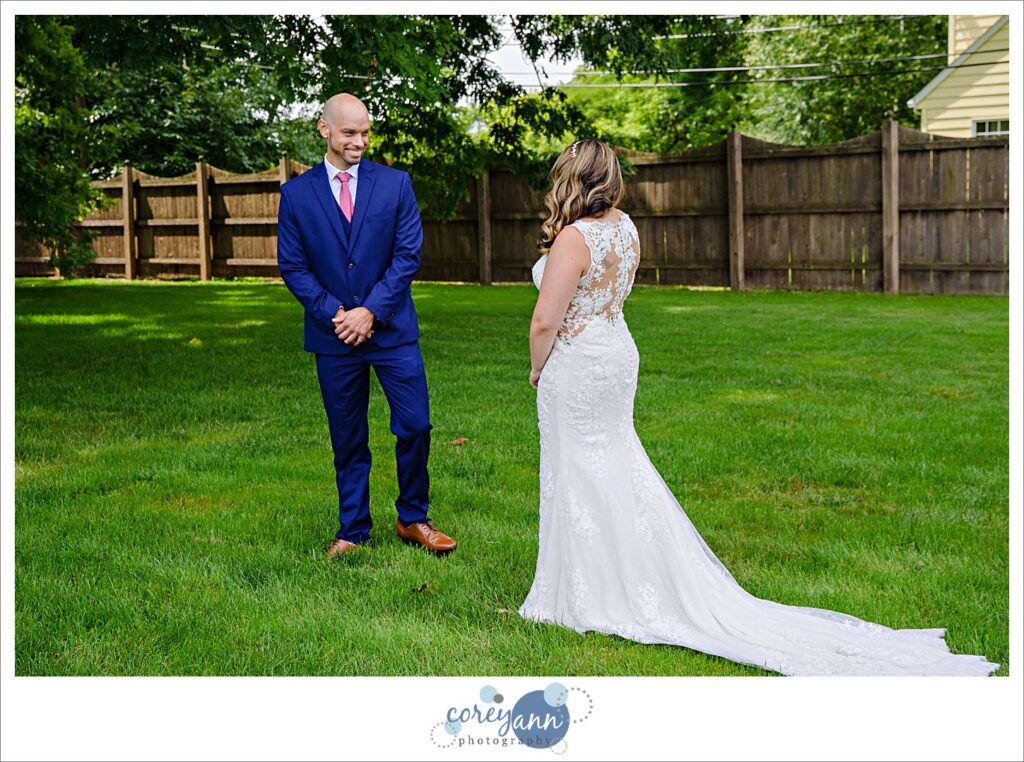 first look between bride and groom in the outdoor wedding ceremony space at Whitehall Columbia in Ohio