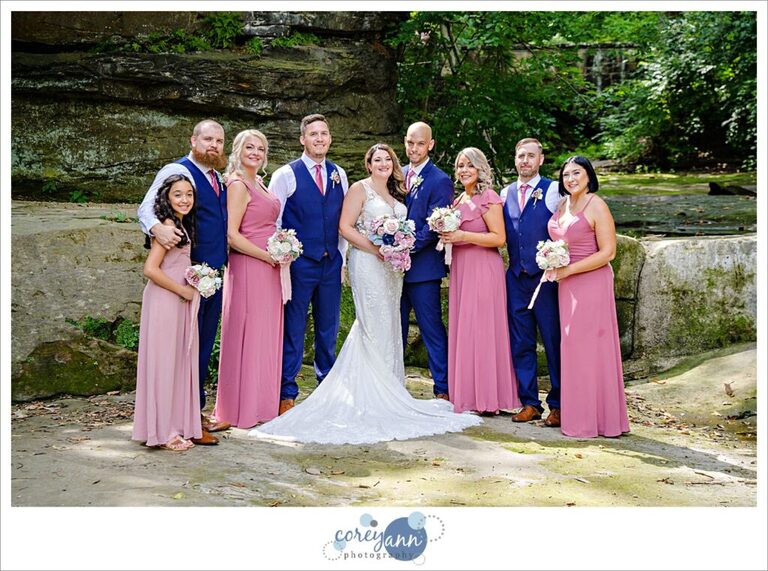 Pink and blue bridal party posing for a portrait after a wedding in Olmsted Falls Ohio