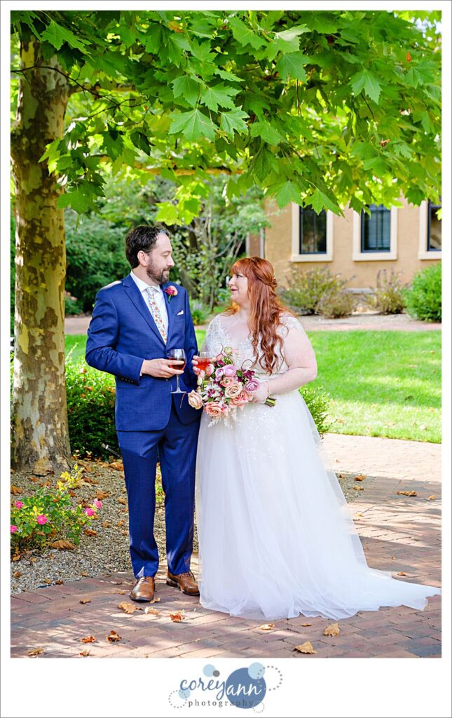 Bride and groom sharing a glass of wine before ceremony at Gervasi Vineyard in Canton Ohio