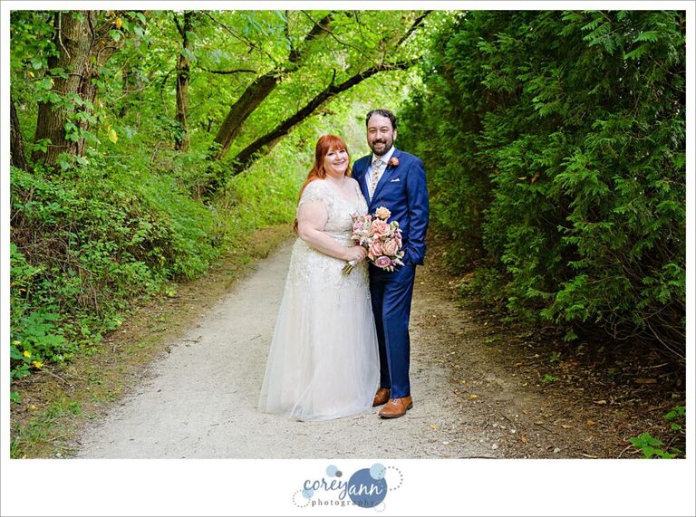 Bride and groom posing on wooded trail near Gervasi Vineyard in Canton Ohio 