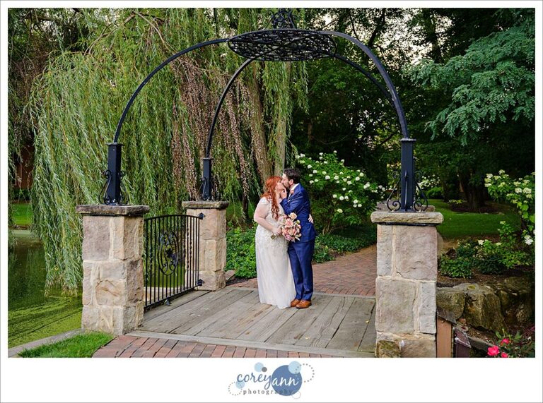 Bride and groom posing on the bridge at Gervasi Vineyard in Canton Ohio after their wedding ceremony