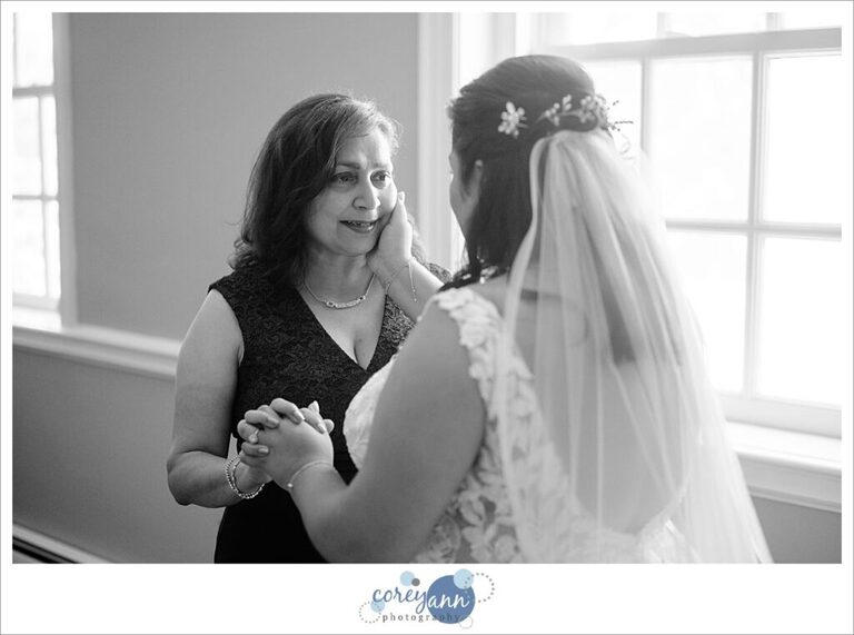 bride getting dressed for her wedding at manakiki golf course in  Willoughby Ohio