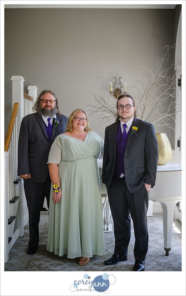Groom and his family pose for a portrait before wedding ceremony outdoors at Manakiki Golf Course in Ohio