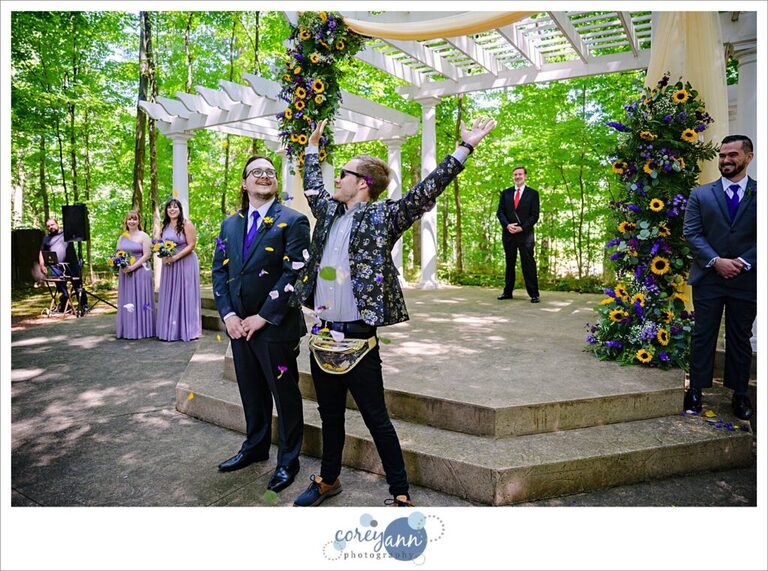 Flower Dude raining rose petals down on the groom before the wedding ceremony at Manakiki Golf Course