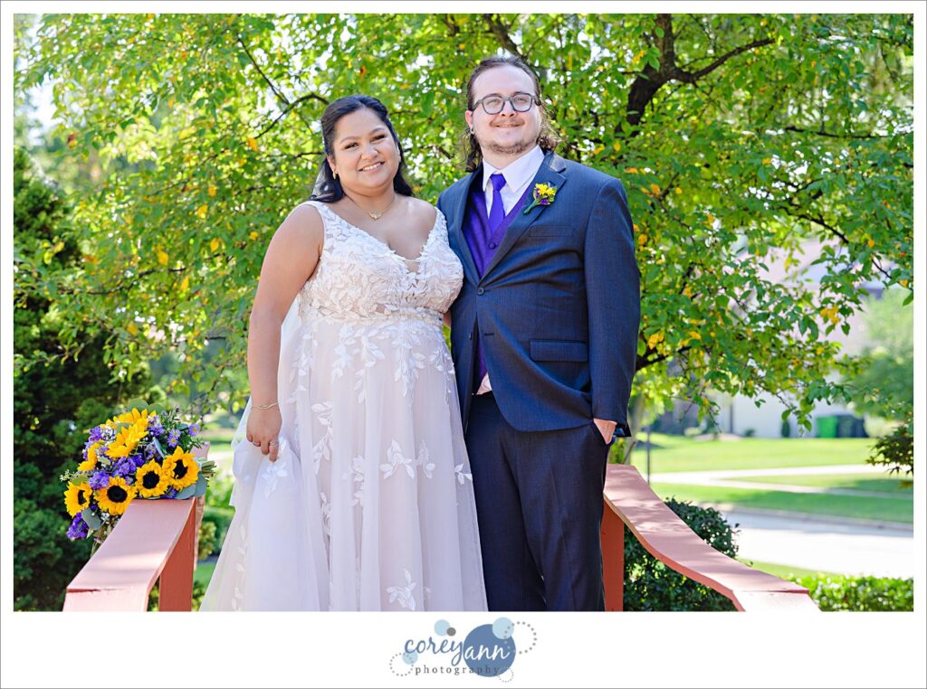 Bride and groom posing on a bridge at the bride's parent's house 