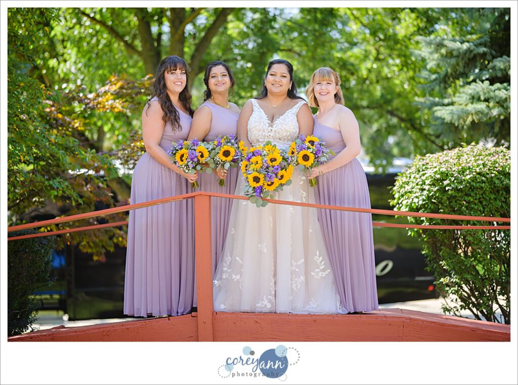 Bride and bridesmaids posing after wedding ceremony in Northeast Ohio