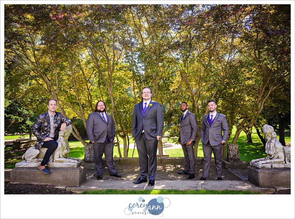 Groom and groomsman posing at Coulby Park in Wickliffe Ohio for wedding photos