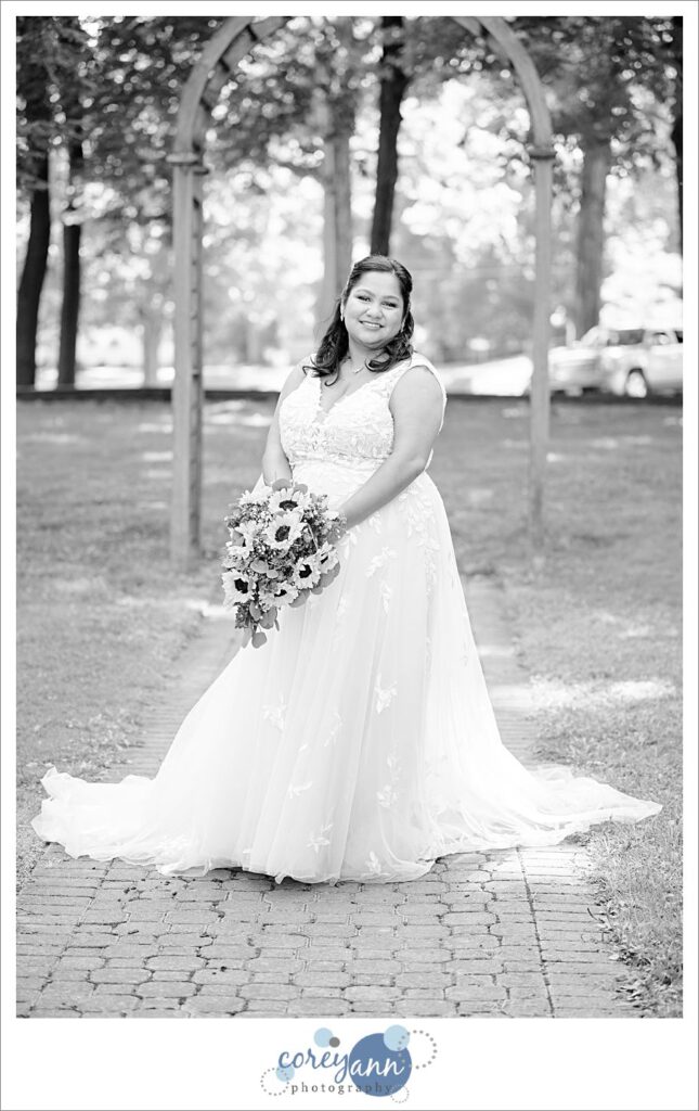 Bride posing near arch at Coulby Park in black and white