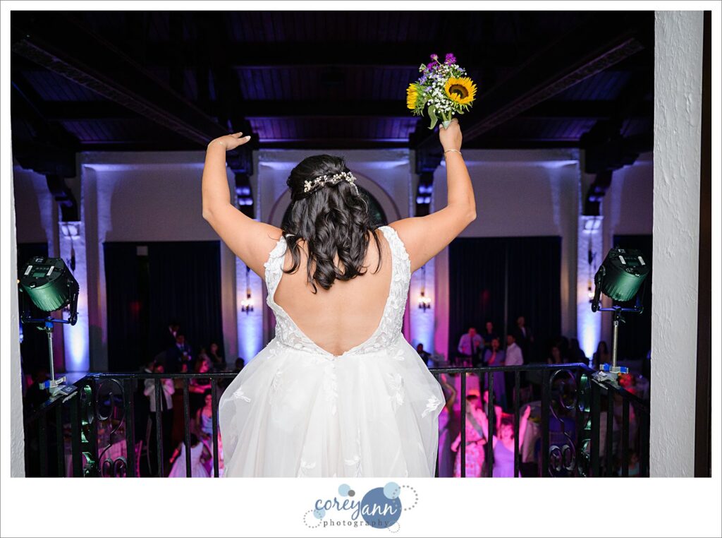 Bride tossing bouquet wedding reception at Pine Ridge Country Club in Wickliffe Ohio