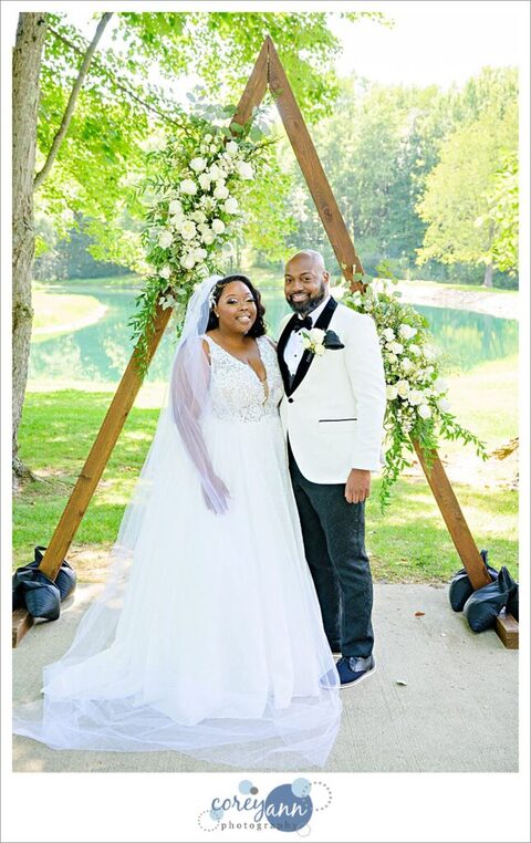 Bride and groom posing at Sun Valley Ohio before their wedding in August