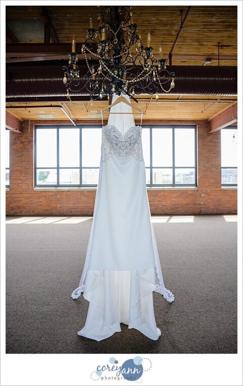 Wedding gown and veil hanging from a chandelier 