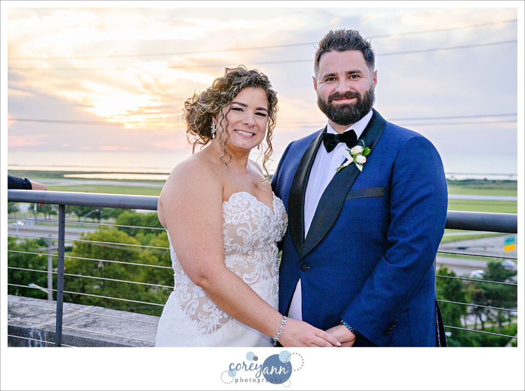 Bride and Groom posing at sunset in Cleveland on top of the roof at Ariel International Center