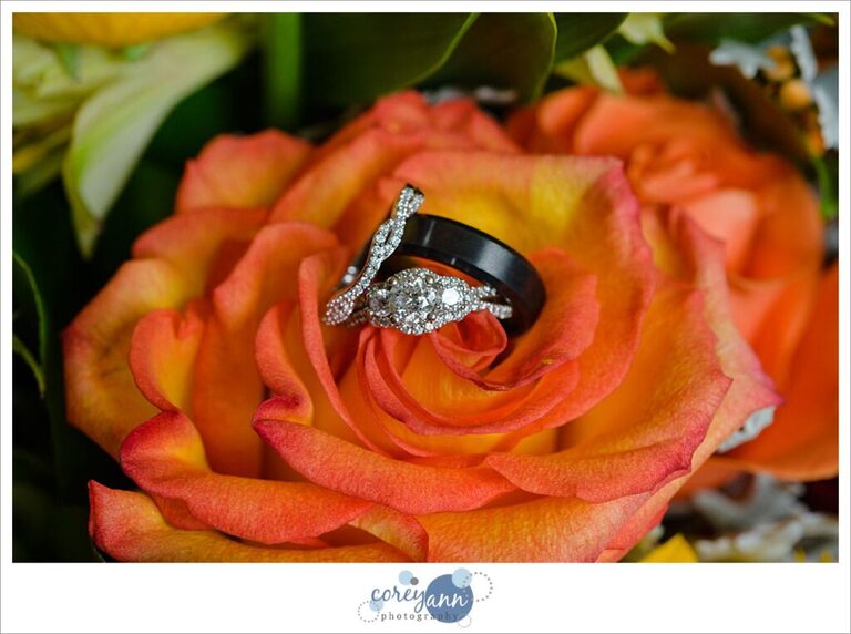 wedding rings in a orange rose 