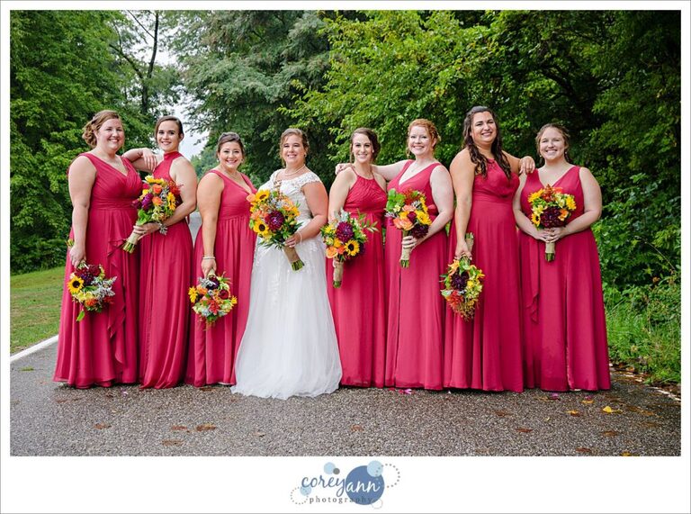 Bride and bridesmaids wearing red dresses with punchy vibrant bouquets