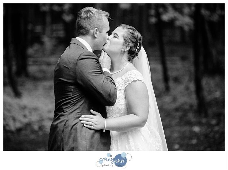 Groom kissing bride in black and white in akron ohio