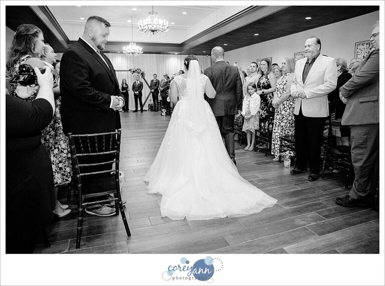 Bride walking down the aisle before wedding ceremony at Gather at the Lakes