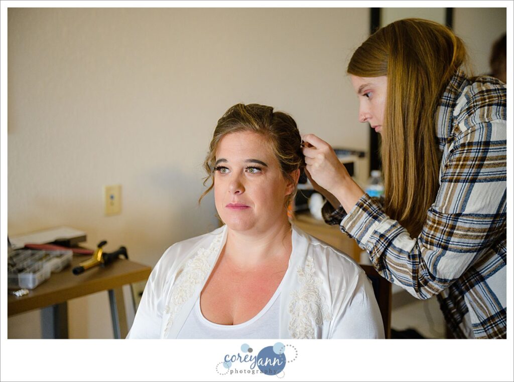 Bride getting makeup done before wedding in Akron Ohio