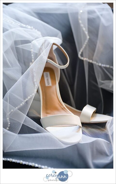 Bride's comfortable wedding heels styled alongside her veil
