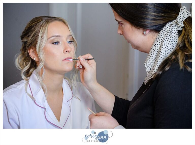 Bride getting her makeup done by My Fair Makeup Aristry before wedding at Tudor House in Akron