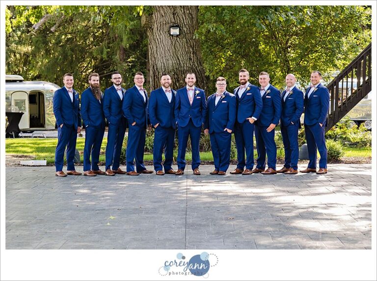 Groom and Groomsman in blue suits with pink ties before wedding in Akron Ohio