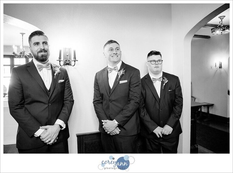 Bride doing first look with her brothers at Tudor House on Mason's Cove on Portage Lakes in Akron Ohio