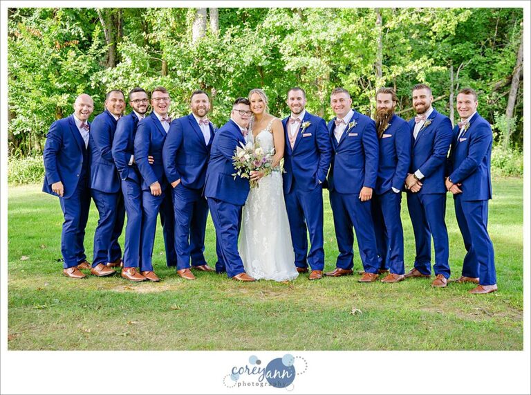 Bride and groom with groomsman posing after wedding ceremony at Tudor House on Portage Lakes