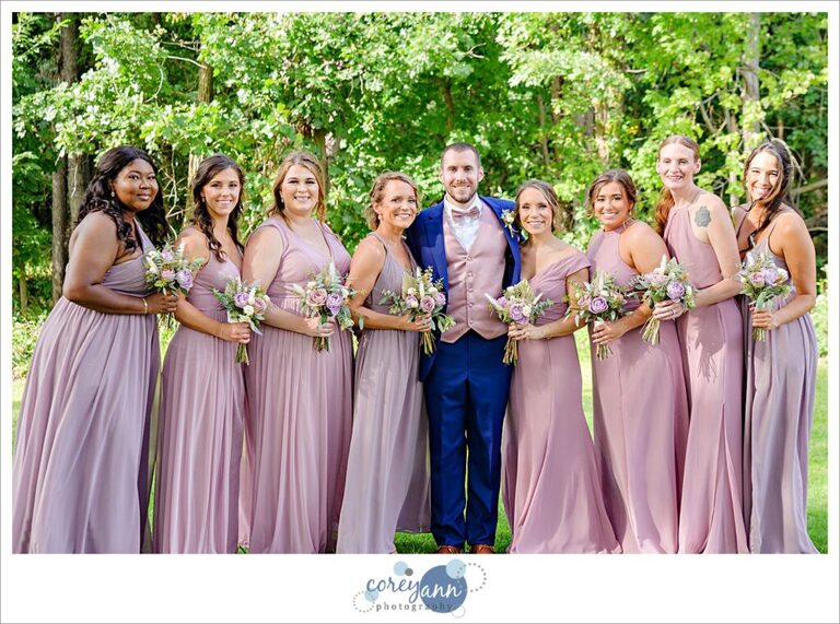 Groom with bridesmaids after wedding in Akron Ohio