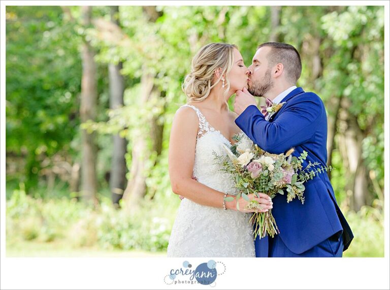 Bride and groom kissing after wedding at Tudor House on Portage Lakes