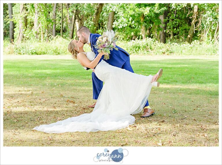 Groom dipping bride during a September wedding at Tudor House on Mason's Cove