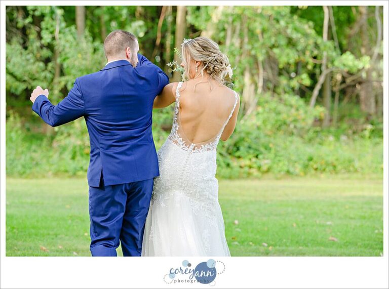 Bride and groom bumping hips after wedding in Akron Ohio