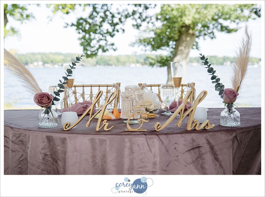 Pink and gold boho decor for a sweetheart table at a wedding at Tudor House on Portage Lakes