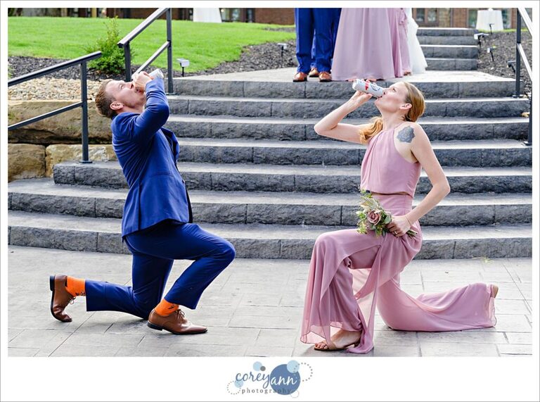 Groomsman and bridesmaid getting iced during wedding reception entrance 
