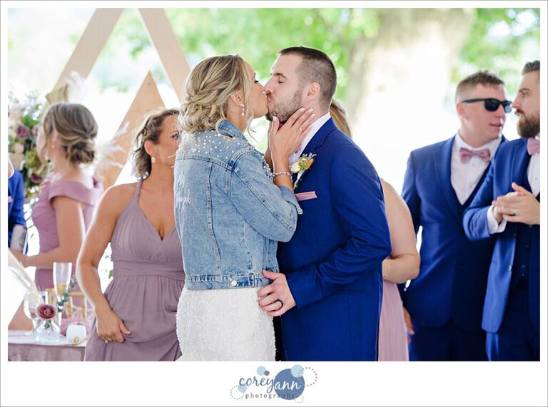 Bride and groom entering wedding reception tent at Tudor House on Portage Lakes