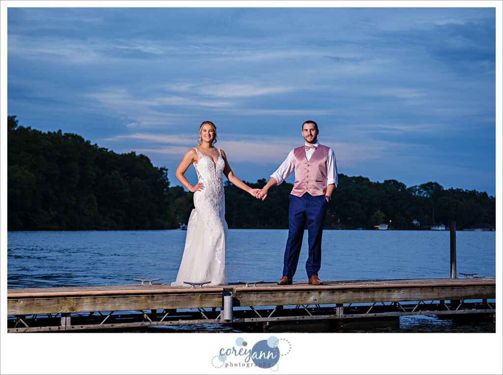 Bride and groom posing on Turkeyfoot Lake in Akron Ohio at sunset
