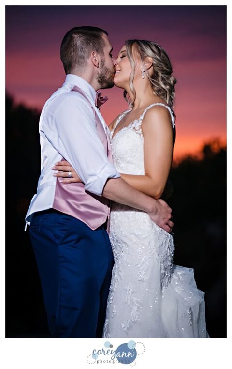 Bride and groom posing at sunset at Tudor House on Mason's Cove
