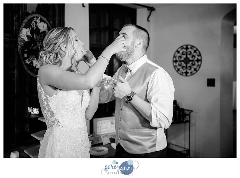Bride and groom cutting the cake at wedding reception