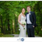 Bride and groom posing in September at Huntington Reservation in Cleveland in a forested lane in Ohio