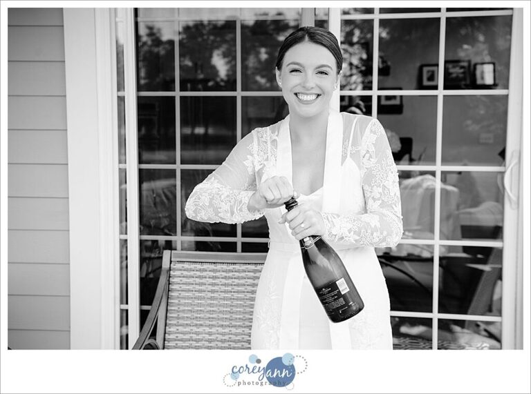 Bride popping champagne before wedding in Ohio