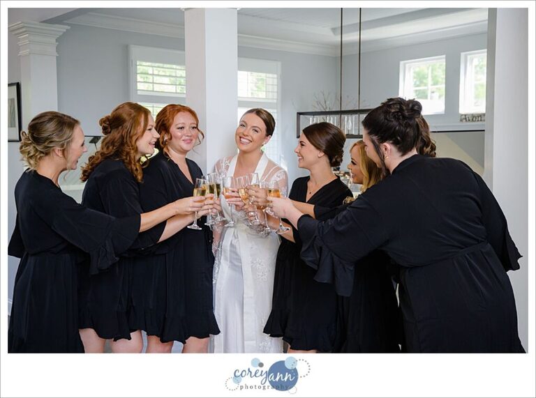 Bride and bridesmaids toasting with champagne before wedding in Ohio