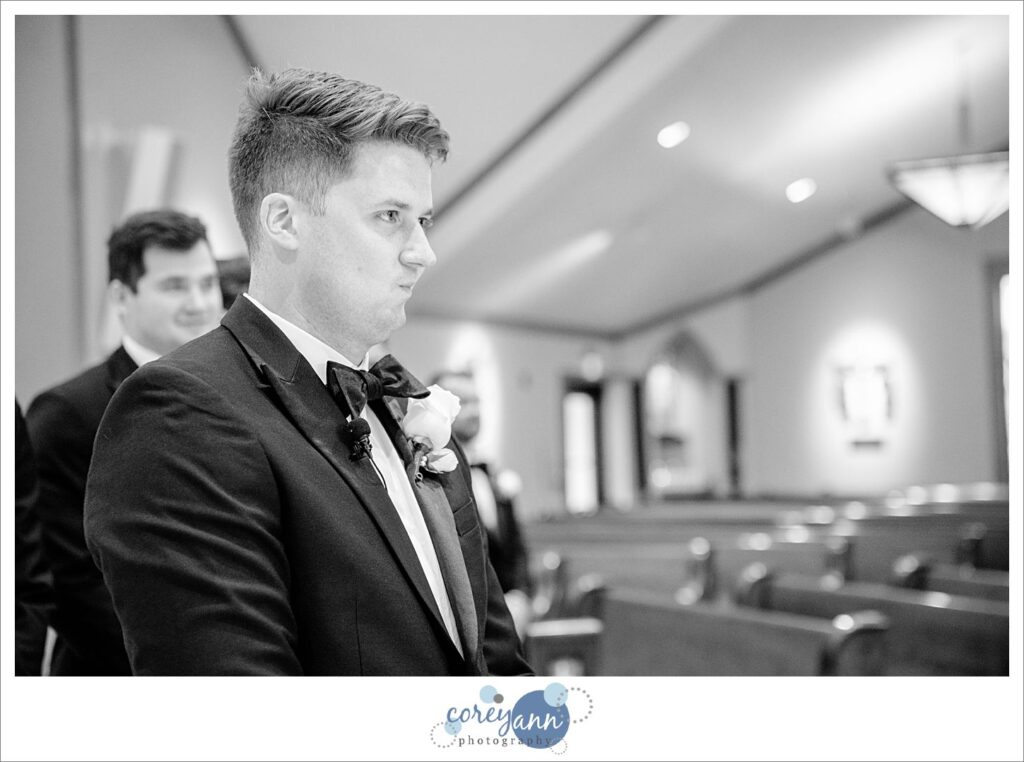 Groom trying not to cry when seeing the bride for the first time at St. Raphael Parish