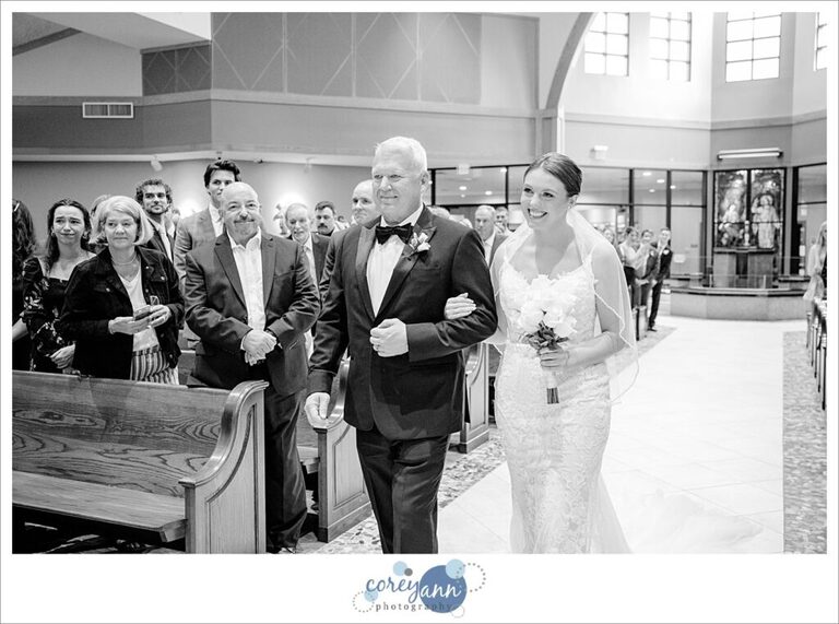 Bride walking down aisle at St. Raphael Parish wedding ceremony
