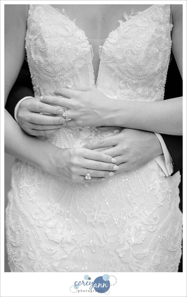 Bride and Groom placing rings on each others hands after wedding in Ohio