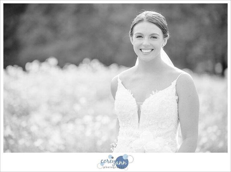 Black and white portrait of a bride in a field of wildflowers after wedding in Avon Ohio