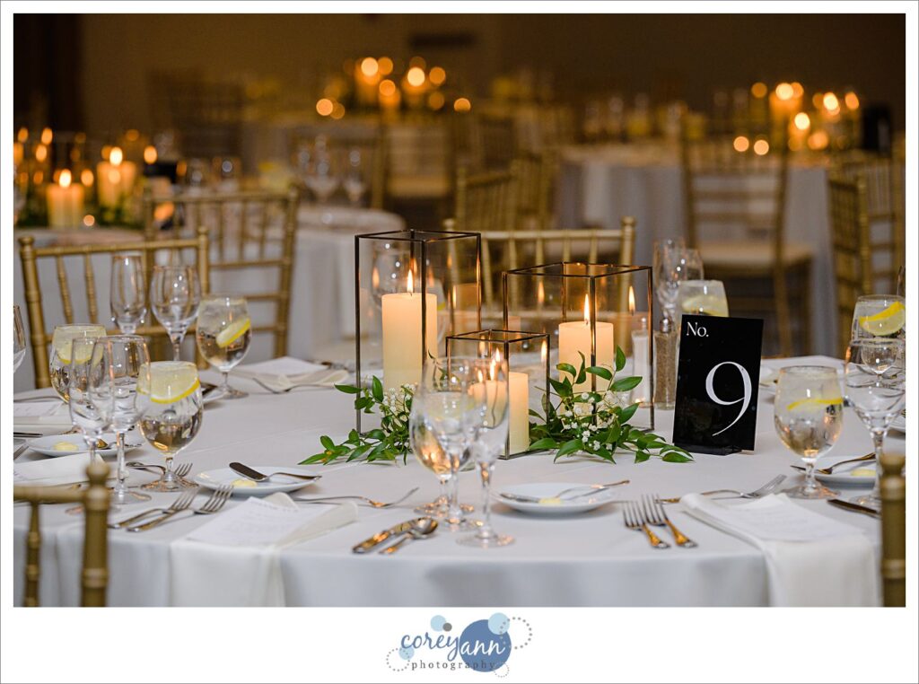 Neutral candle and glass table decor for a wedding reception at Emerald Event Center in Ohio