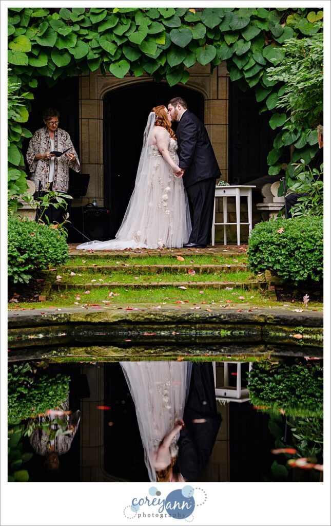 First kiss after a wedding ceremony at Stan Hywet Hall and Gardens in the English Garden 