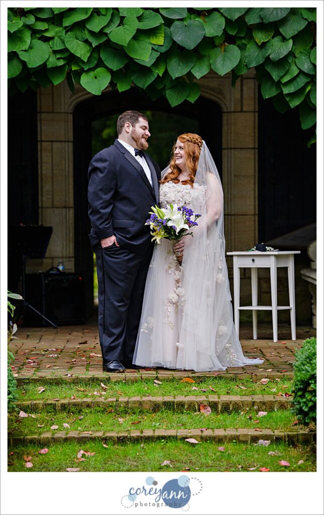 Bride and Groom smiling at each other after their wedding ceremony in a tender moment. 