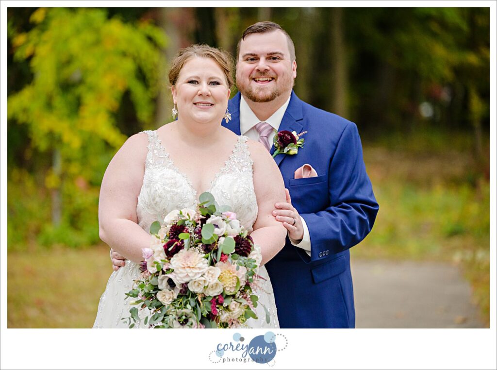 Bride and Groom wearing traditional wedding attire posing after fall wedding at Tudor House on Portage Lakes in Akron Ohio